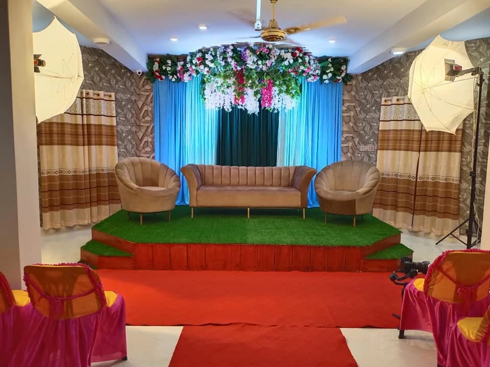 Blue-curtain stage and seating at Crystal Community Center, Gobindaganj