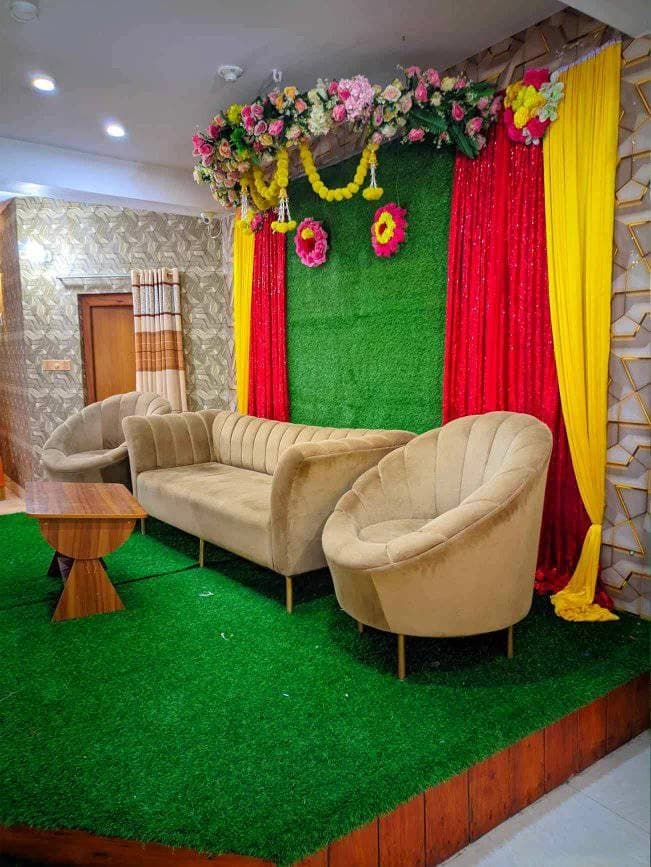 Gaye Holud stage with red and green backdrop at Crystal Community Center, Gobindaganj